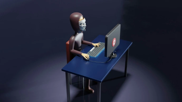 a skeleton sitting at a desk with a laptop and keyboard